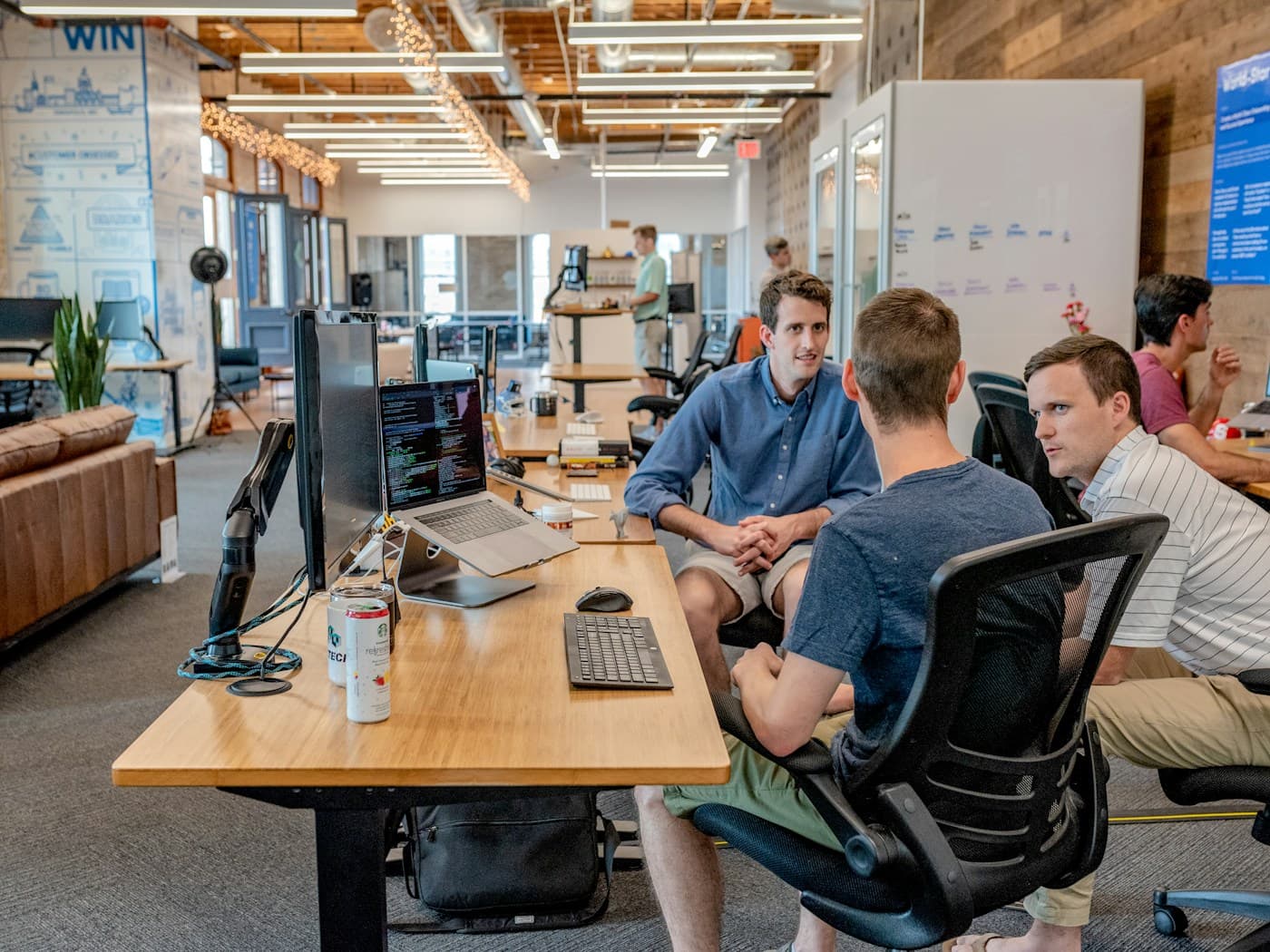Student founders discussing a startup pitch in a meeting room